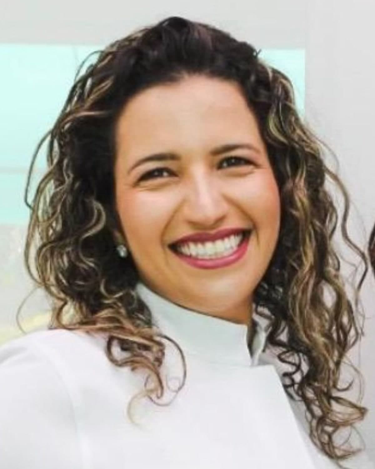Dra. Bela Romio, Cirurgiã-Dentista, em retrato de meio corpo no consultório